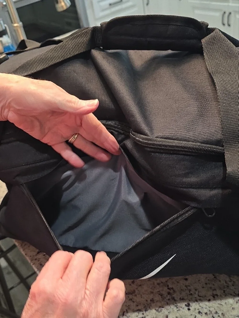 Nike Black Duffel Bag with White Swoosh and Branded Strap